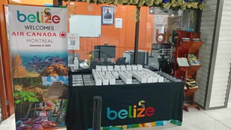 A welcome display for Air Canada featuring Belize, with a table of gifts and promotional materials.
