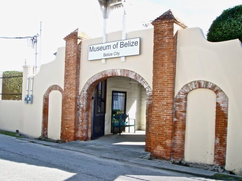 Entrance to the Museum of Belize in Belize City featuring a brick archway and sign.